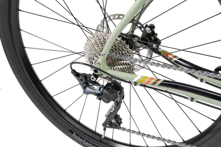Shimano Ultegra RX rear derailleur and cassette on the 2021 Bombtrack Audax, beside the sage green frame stripes.
