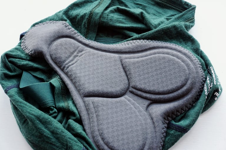 Grey chamois pad inside the green merino Vulpine Padded Boy Shorts, thinner than a full cycling short pad.