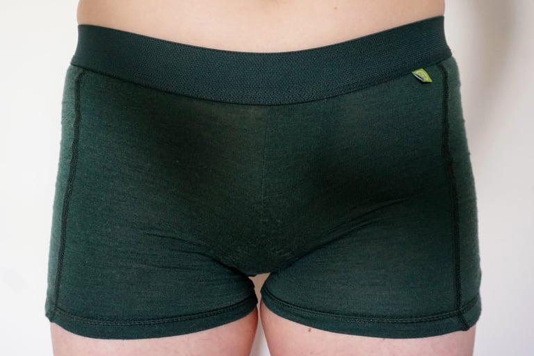 Vulpine Merino Padded Boy Shorts in dark green with a wide elasticated waistband, worn front view.