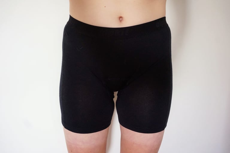 Alpkit Kepler padded merino boxers in black, a longer-leg cut, worn front view.