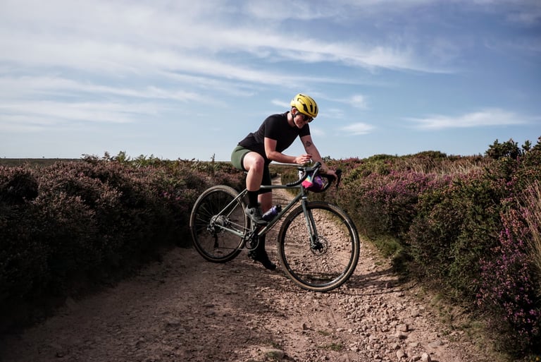 Rider on the Temple Adventure Disc 1 on a rocky trail through heather in the Quantock Hills.