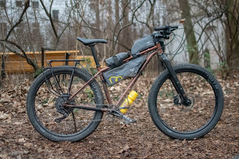 Joachim Rosenlund's Bombtrack Beyond with Apidura frame bags and the Downtube Pack strapped along the top tube.