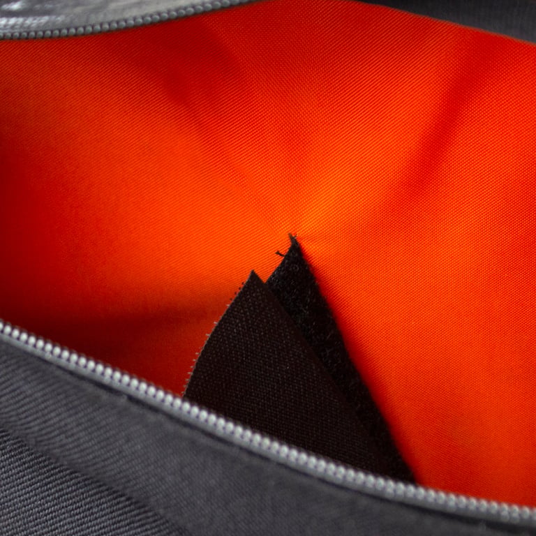 Inside a Restrap custom frame bag, showing the orange lining and the black velcro inner divider.