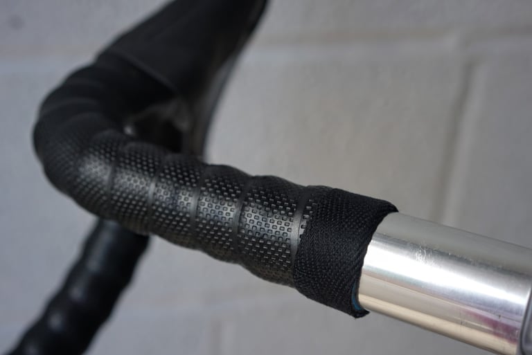 Brooks Cambium rubber bar tape finished with black cotton webbing tape on silver alloy bars.