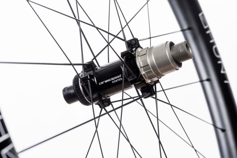 CeramicSpeed Coated rear hub and freehub on a Hunt 42 Limitless Gravel Disc wheel, shot against white.