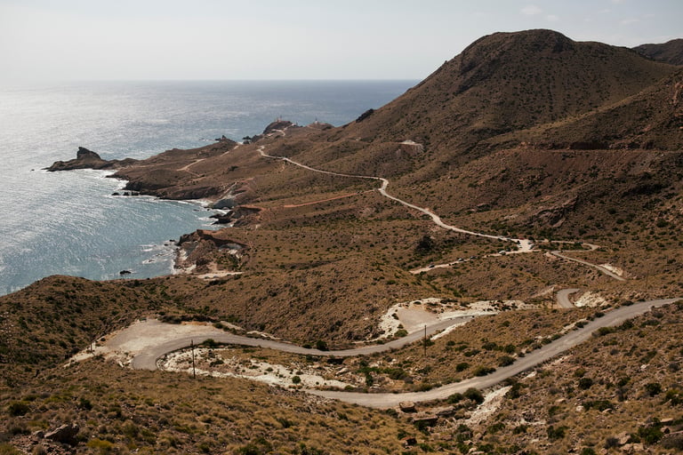 Road and track wind along the Almeria coastline at Cabo de Gata, with the sea to the left.