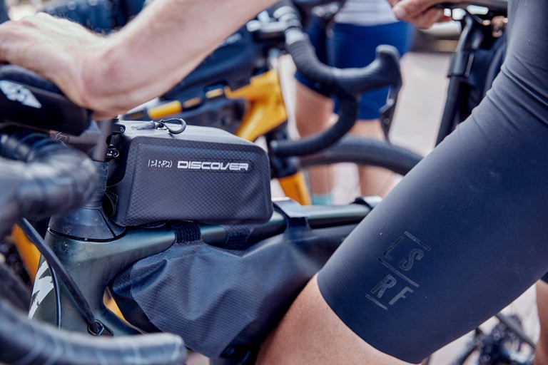 PRO Discover Team top tube bag behind the stem, with a frame bag below it, on a gravel bike.