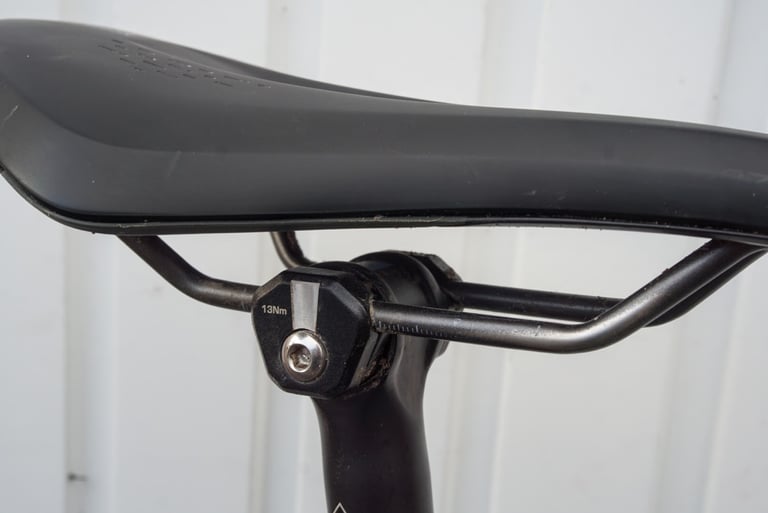 Fizik Terra Argo X3 saddle rails in the seatpost clamp, showing the generous clamping area and 13Nm marking.