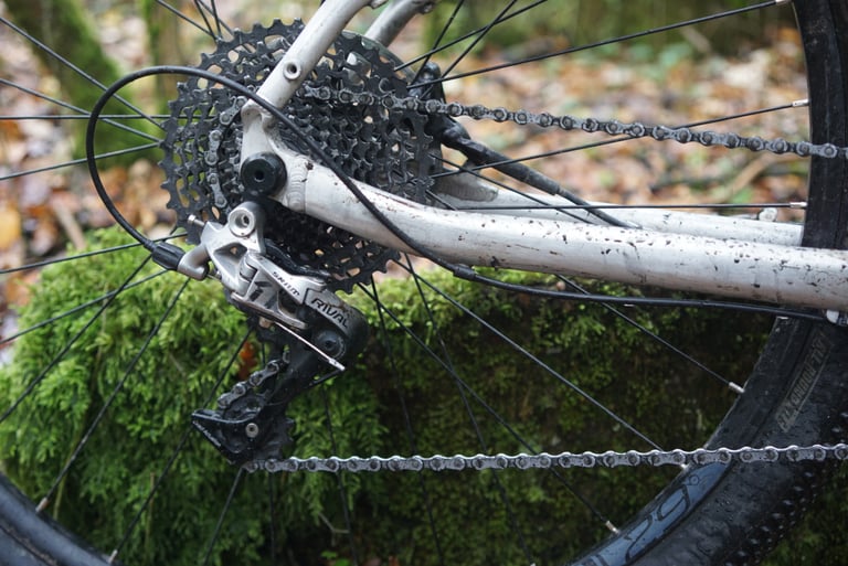 SRAM Rival rear derailleur and 11-42T cassette on the Riverside 920 prototype, set against moss.