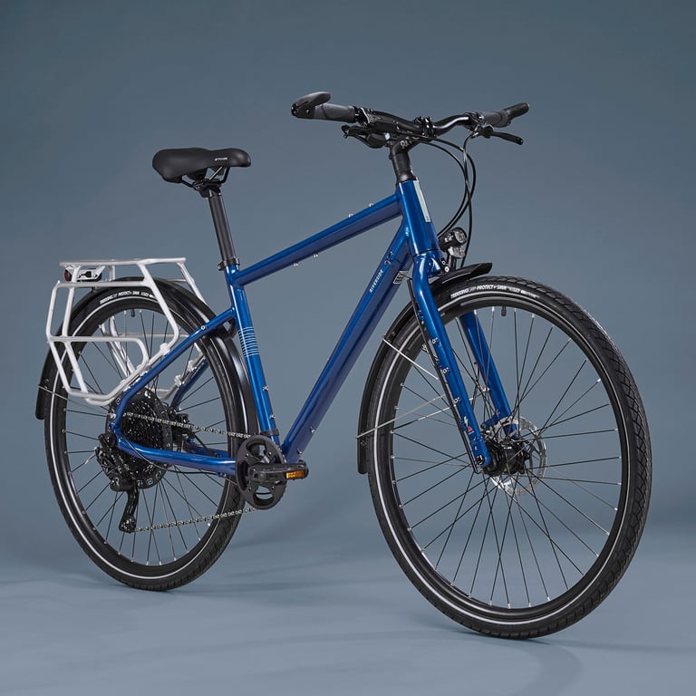 Riverside Touring 520 in blue with rear rack, mudguards, dynamo light and flat bars, studio three-quarter view.