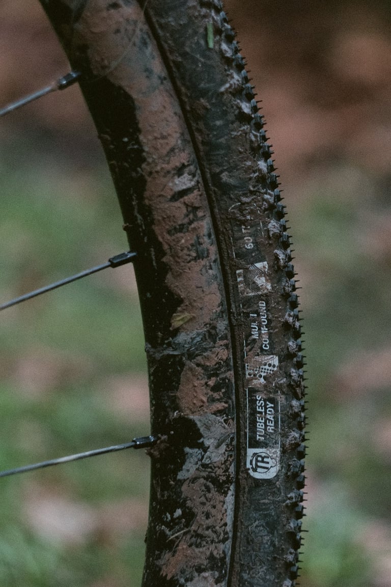 Halo GXC tyre sidewall with tubeless ready and multi compound labels, caked in mud.