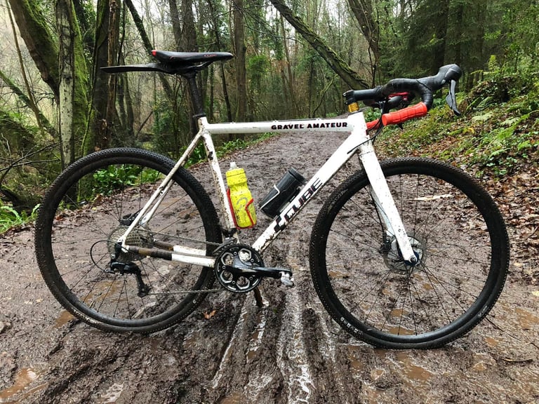 White Cube CX gravel bike with Halo GXC tyres standing on a muddy woodland track.