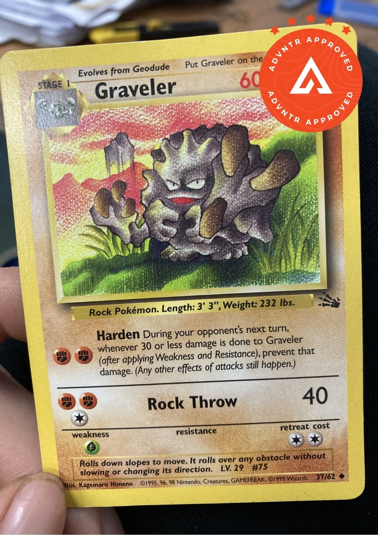 Graveler Pokemon card showing the rock Pokemon with its Harden and Rock Throw attacks, held in a hand.