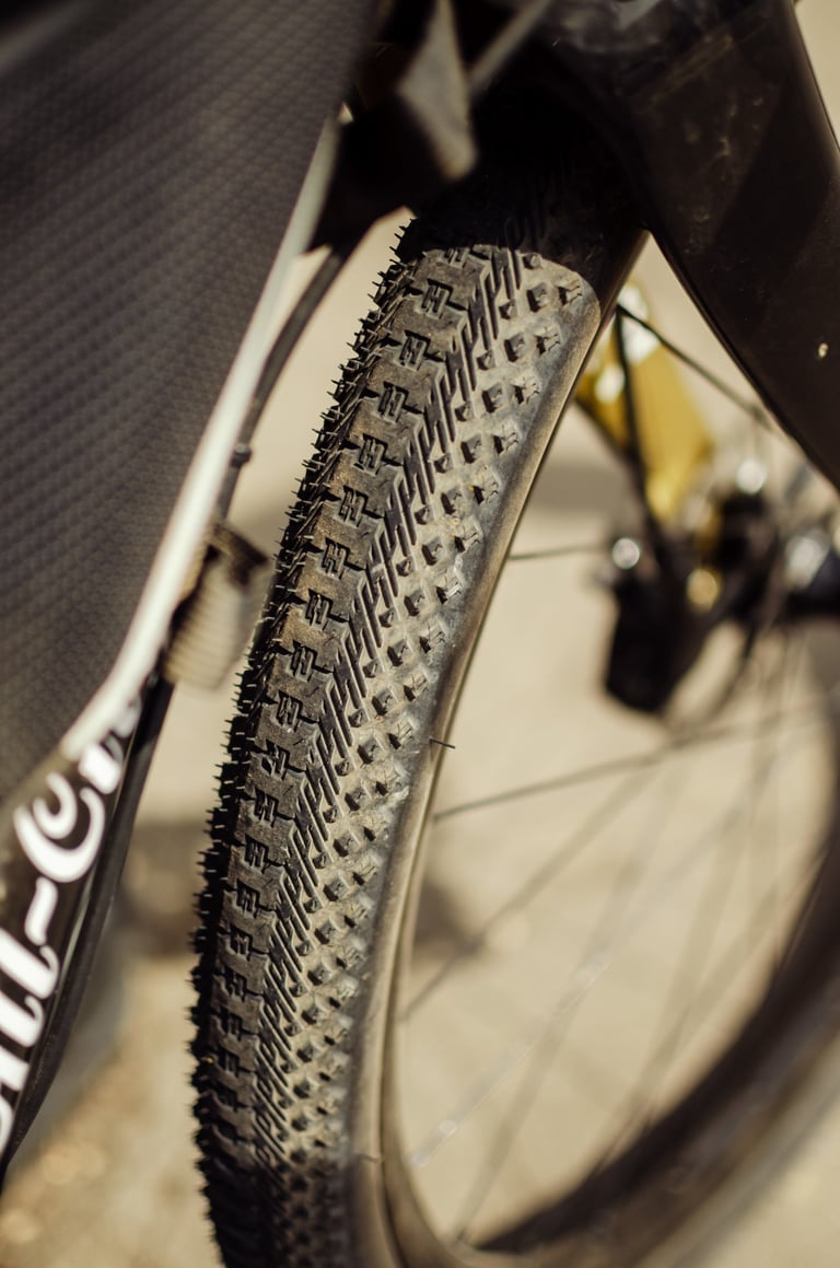 Halo GXR gravel tyre mounted in a bike fork, with a fast-rolling centre tread and larger blocks on the shoulders.