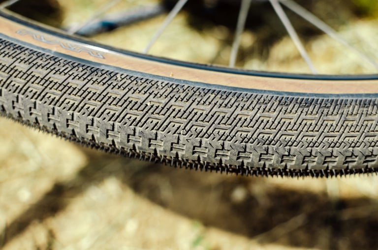 Halo RXR gravel tyre with tan sidewall, showing its fine, tightly packed tread for road and hardpack.