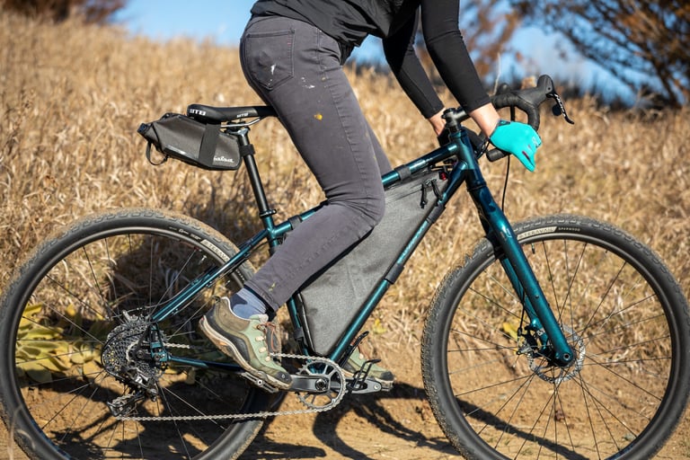 2021 Salsa Fargo with frame bag and saddle bag, ridden on a dry dirt trail on wide Teravail tyres.