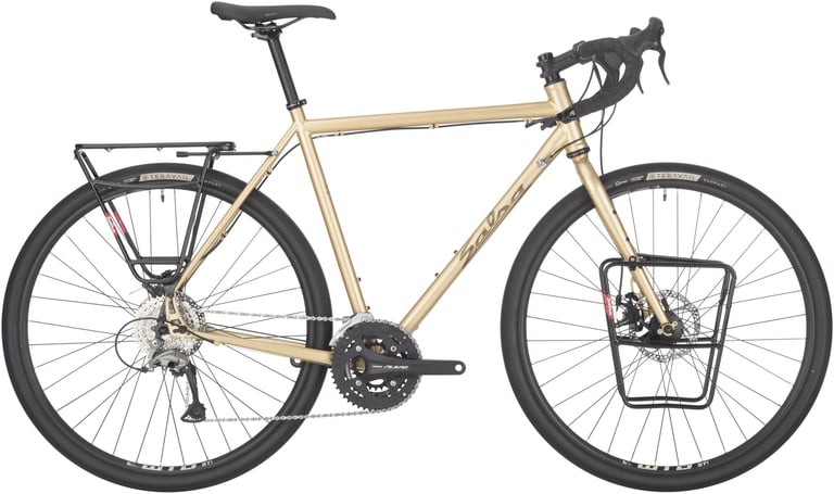Salsa Marrakesh touring bike in gold with front and rear racks, drop bars and Teravail Rampart tyres, side view.