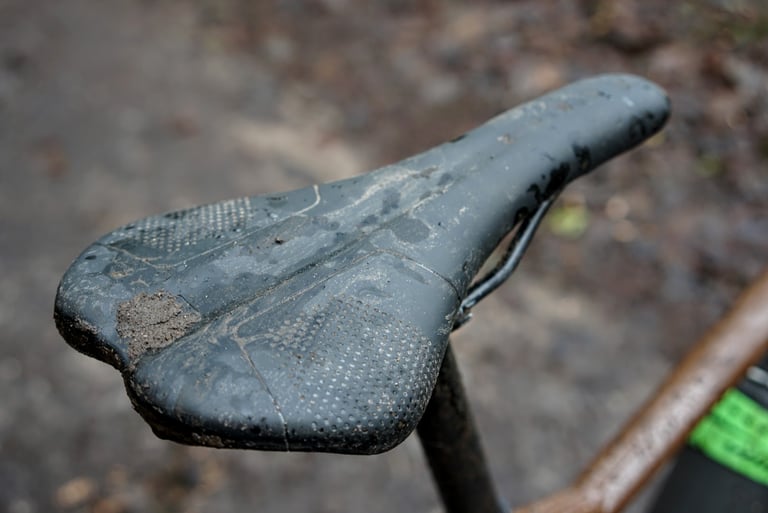 Muddy Marin saddle on the DSX 2 showing the central groove and textured grip panels.