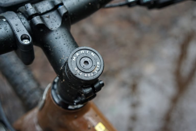 Marin DSX 2 stem cap stamped 'Made for Fun' above the bars, speckled with rain.
