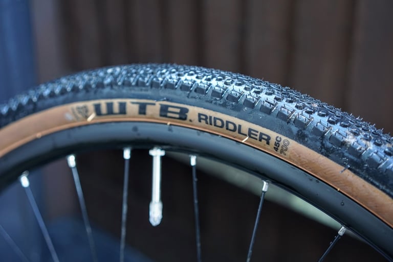 Side of a 700c x 45 mm WTB Riddler gravel tyre with tan sidewall on the Marin DSX 2 rim.