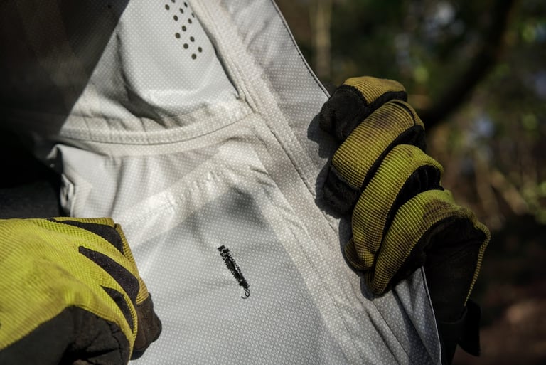 Inside the TSG Drop Rain Jacket, a small hole by the chest pocket lets a headphone cable pass through.