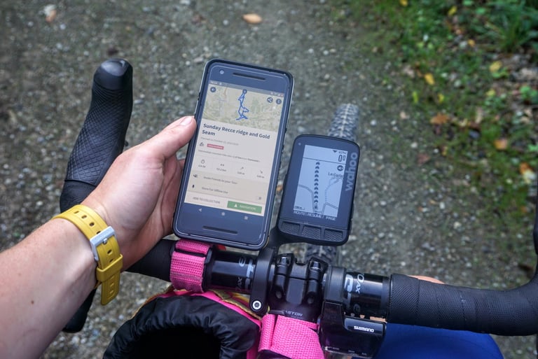 Wahoo ELEMNT ROAM on the bars beside a phone showing a komoot route, Sunday Recce ridge and Gold Seam.