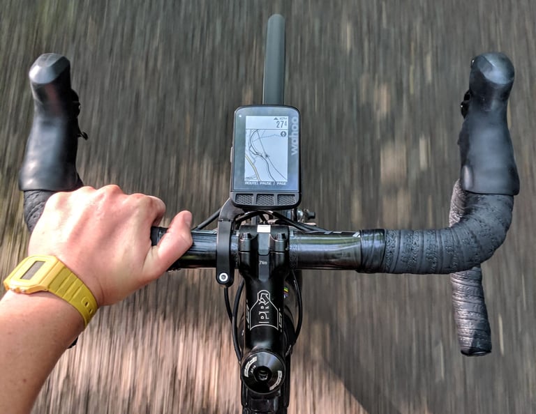 Wahoo ELEMNT ROAM on its out-front aero mount, seen from the rider's view on a drop-bar bike in motion.