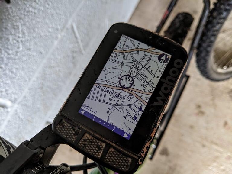 Wahoo ELEMNT ROAM map screen with a crosshair over a town, used for the 'take me to' feature.