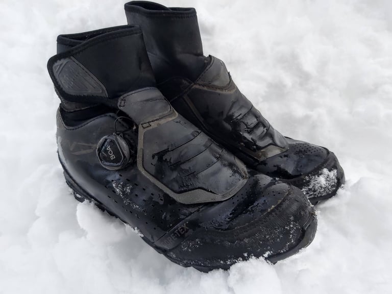 Shimano MW7 winter SPD boots with a BOA dial, wet and crusted with snow after a sub-zero test ride in Ontario.