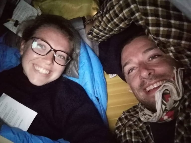 Two campers squeezed in together for a night-time selfie inside the snug Zephyros Compact 2 two-person tent.