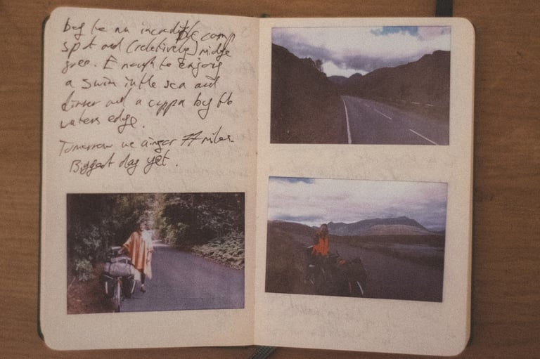 Open field diary with handwritten notes and three Polaroids of the loaded tandem on Highland roads.