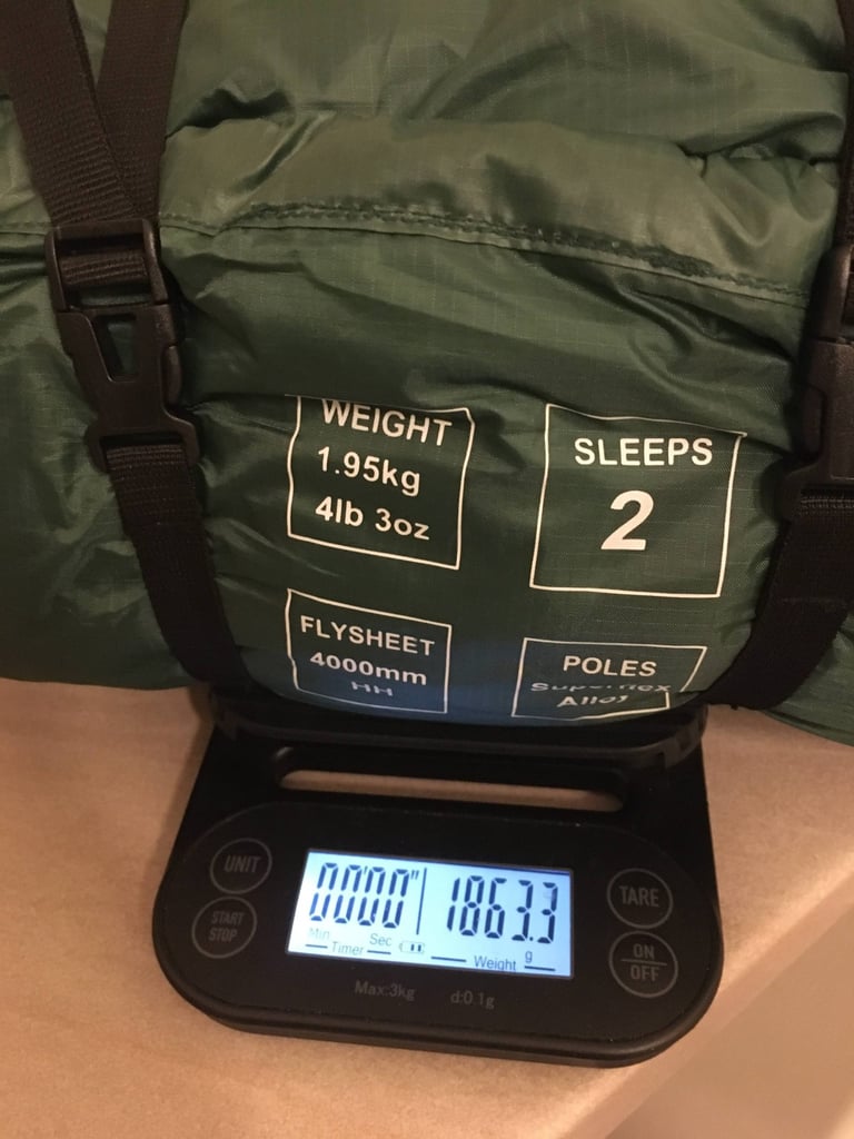 Packed Zephyros Compact 2 tent on kitchen scales reading 1,863g, its bag printed with a claimed weight of 1.95kg.