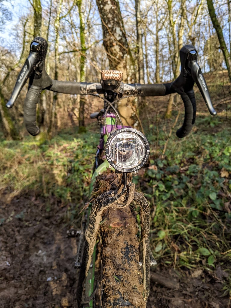 Son Edelux II dynamo light on the Fairlight Faran's fork crown above a muddy tyre, GRX levers behind.