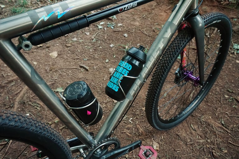 Close view of the Planet X Tempest titanium frame with Zefal pump, two bottle cages and the custom-painted fork.
