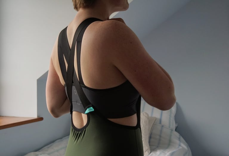 Velocio LUXE bra worn under the criss-cross straps of the matching khaki bib shorts, seen from behind.