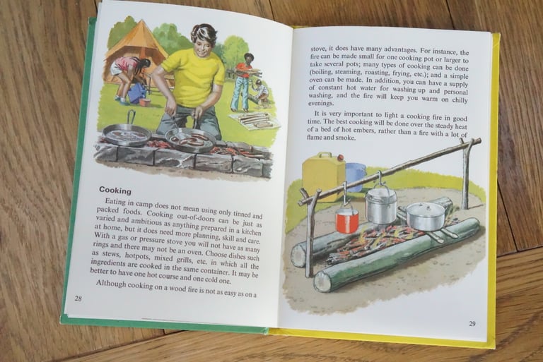 Ladybird camping book cooking pages with a boy frying sausages over a stone hearth and pots hung from a pole over a fire.