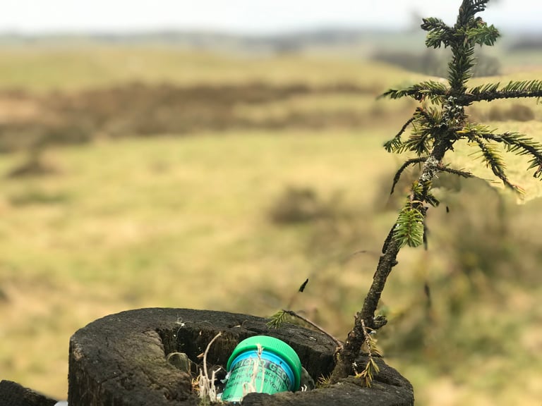 Geocache container hidden in a fence post at Whitelee Wind Farm on the Glasgow Inner Circle gravel route.