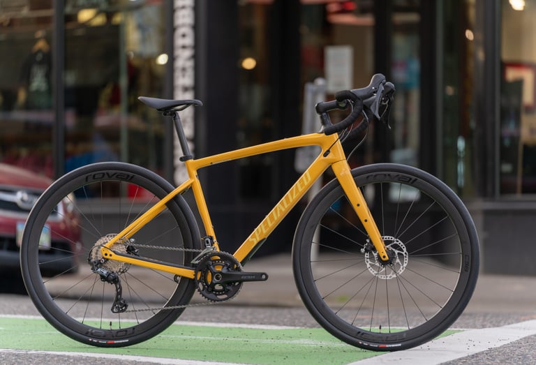 Yellow 2021 Specialized Diverge gravel bike fitted with Roval Rapide C38 carbon wheels, parked on a city street.