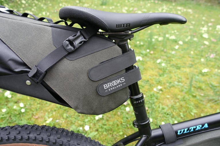 Brooks Scape Seat Bag holster fixed to the seat post with two wide Velcro straps, webbing strap running under the saddle.