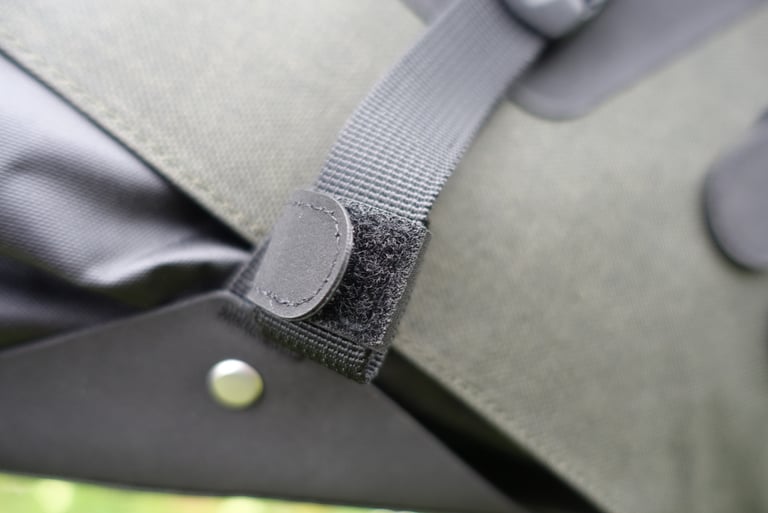 Close-up of a Velcro tab on the Brooks Scape seat bag strap that holds excess webbing neatly in place.