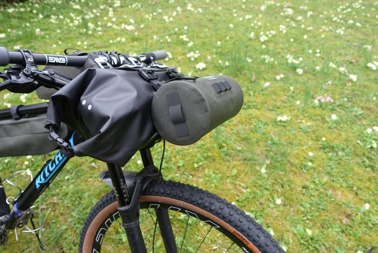 Brooks Scape Handlebar Pouch clipped to the end of the Handlebar Roll on a Ritchey mountain bike for extra storage.