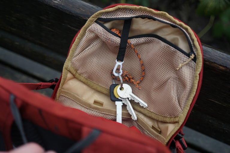 Keys clipped to the toggle inside the top mesh pocket of the EVOC Ride 12L flap.