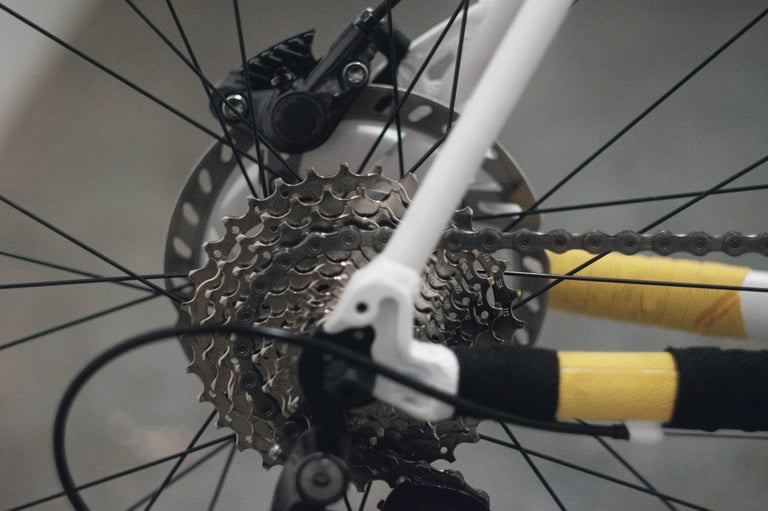 Cassette, rear derailleur and disc rotor on the Cube Cross Race Pro, with yellow cotton tape on the stays.