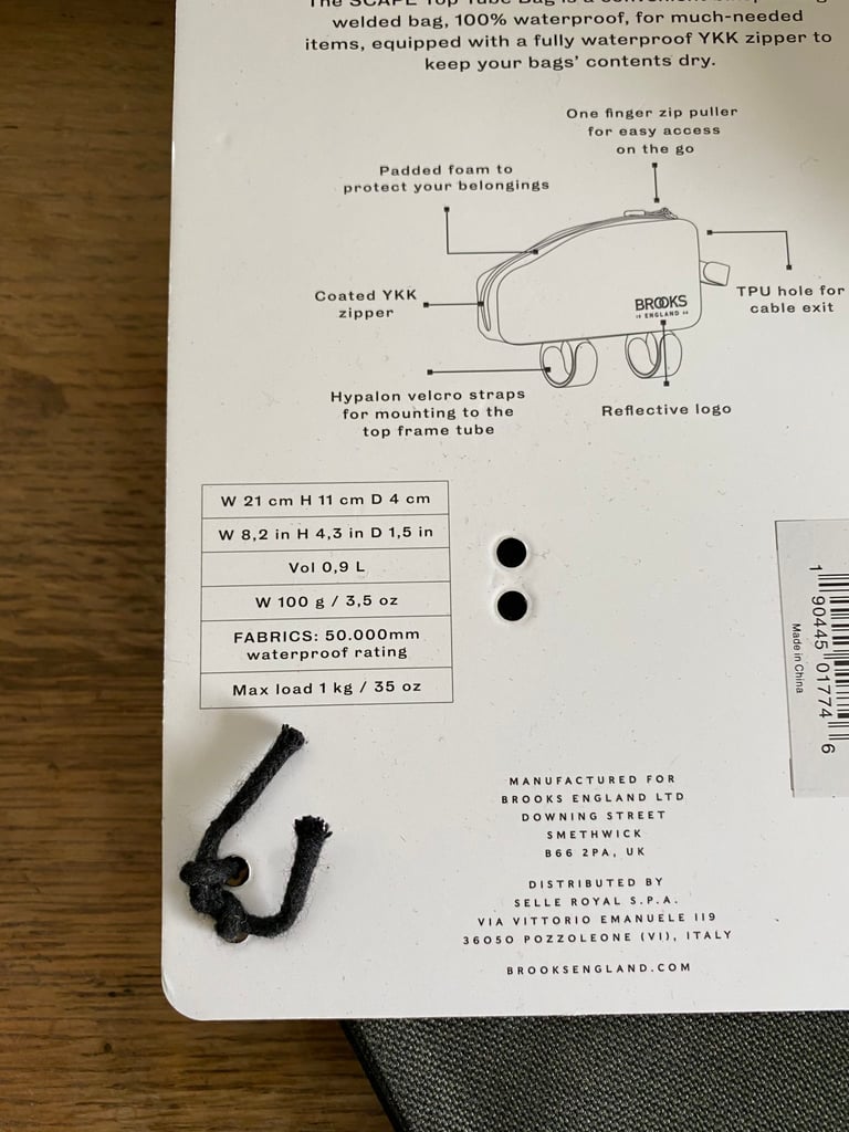 Brooks Scape Top Tube Bag packaging card listing its features, 0.9 litre volume, 100g weight and 50,000mm waterproof rating.