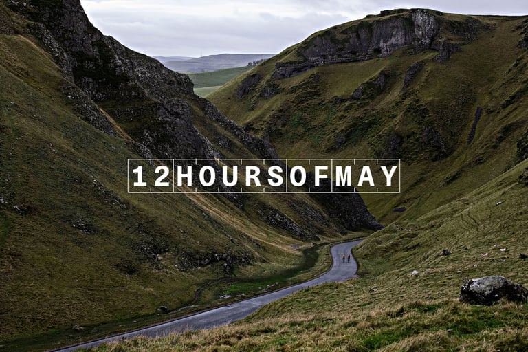 12HoursOfMay graphic over a narrow valley road, with two cyclists in the distance.