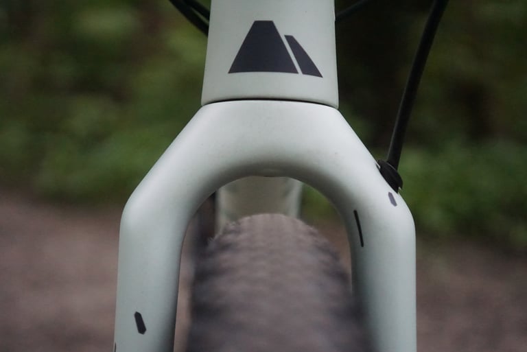 Front view of the Canyon Grizl's carbon fork crown with a wide gravel tyre sitting between the legs.