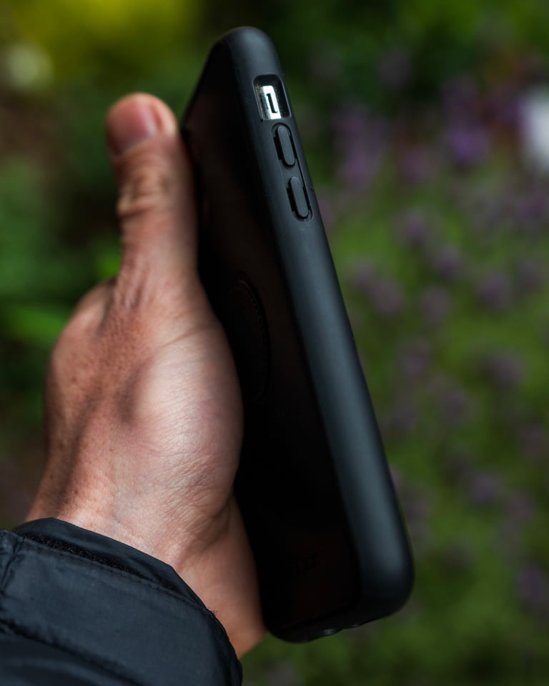 Side of the Fidlock VACUUM phone case held in one hand, with covered volume buttons and a mute switch cut-out.