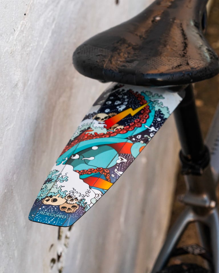 RideGuard Gaiter rear guard in Kraken design, fixed under the saddle rails of a gravel bike.