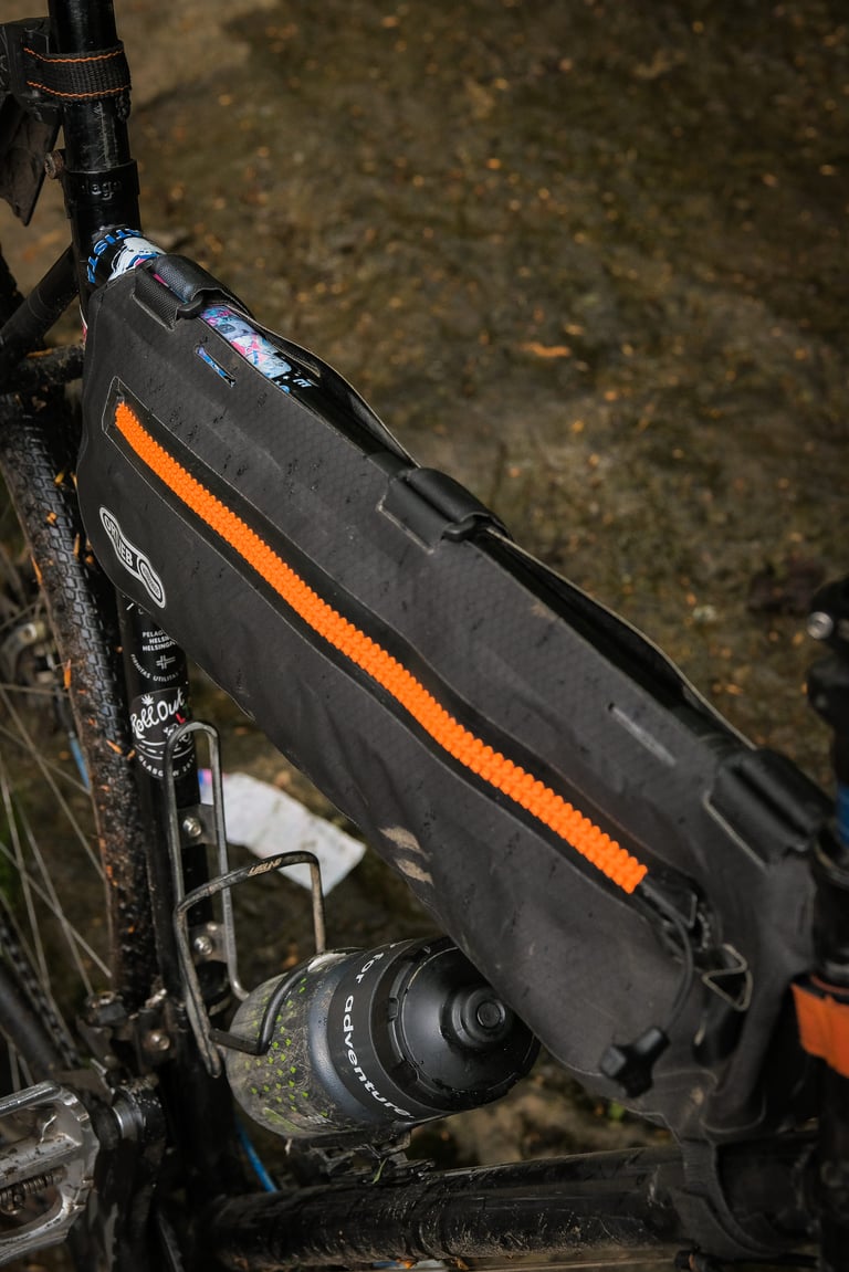 Ortlieb Frame-Pack Toptube with orange zip, seen from above with its Velcro tabs wrapped round the top tube.