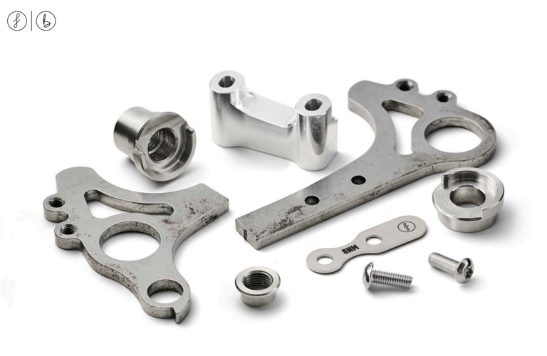 Fairlight Faran 2 dropout parts: laser-cut steel plates, stainless inserts and a CNC aluminium brake mount.